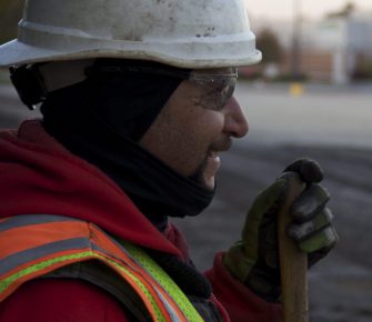 Rabine Paving Worker Wearing Proper Safety Equipment and Safety Goggles